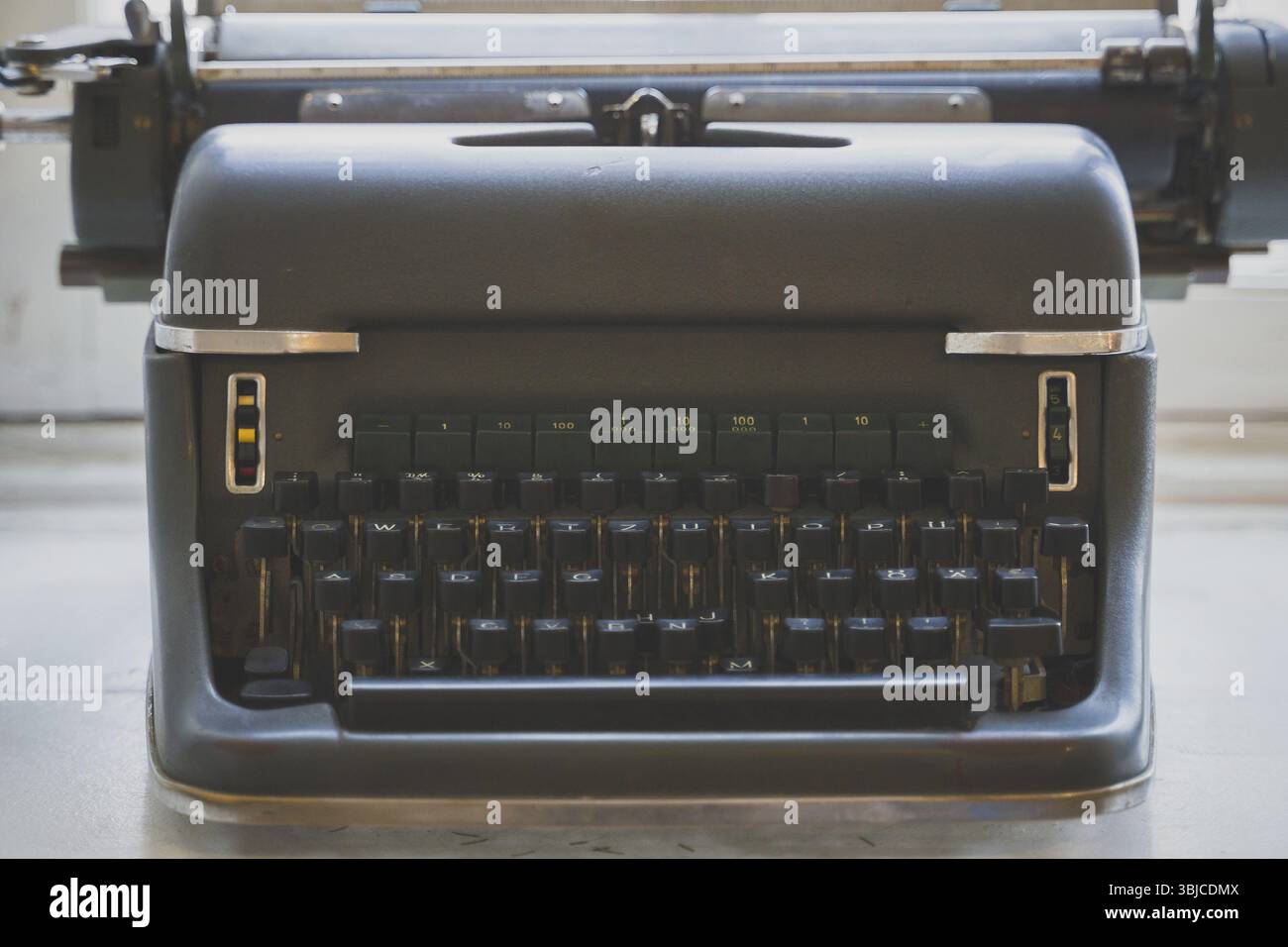 Old retro typewriter standing on the windowsill Stock Photo
