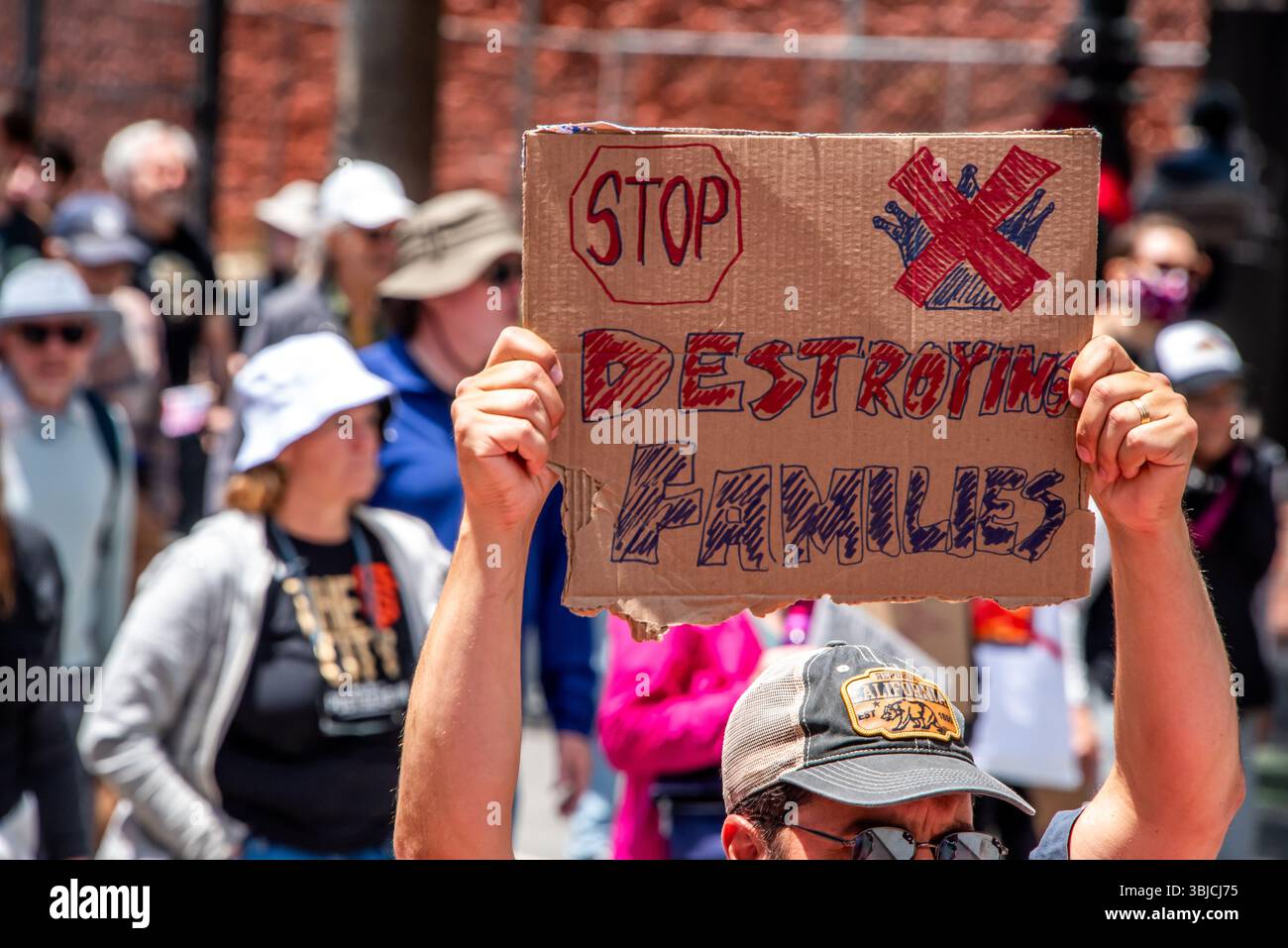San Francisco, USA. 14th June 2025. At the No Kings Day protest and march in San Francisco, a man holds a sign reading, 'STOP destroying families,' in reference to the recent ICE raids and mass deportations led by Donald Trump. Credit: Shelly Rivoli/Alamy Live News - Stock Image
