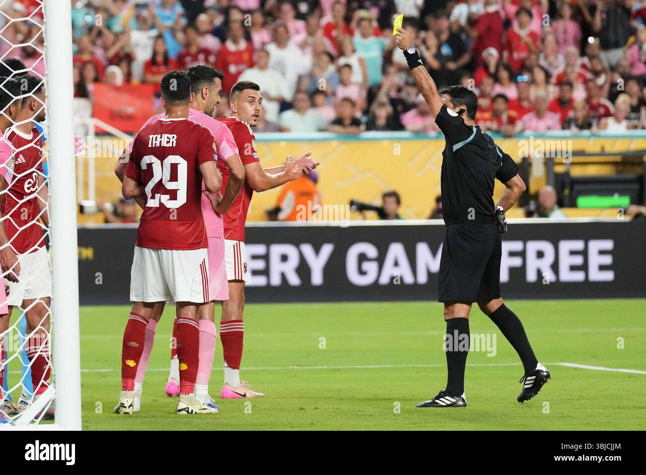 Referee Alireza Faghani shows a yellow card to Inter Miami's Sergio ...