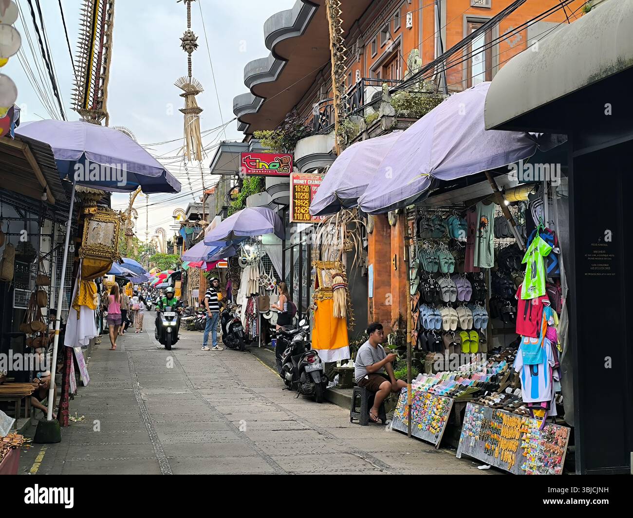 ubud, bali, indonesia, may 16, 2025: ubud art market in a small alley lined with small traders selling various handicrafts and balinese t-shirts Stock Photo