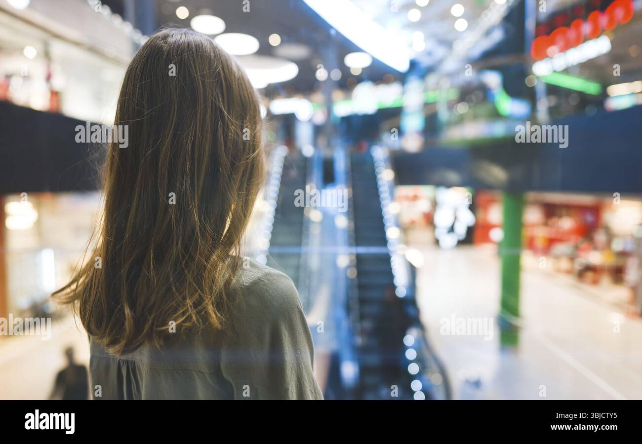 Girl in lift in a large shopping center Stock Photo
