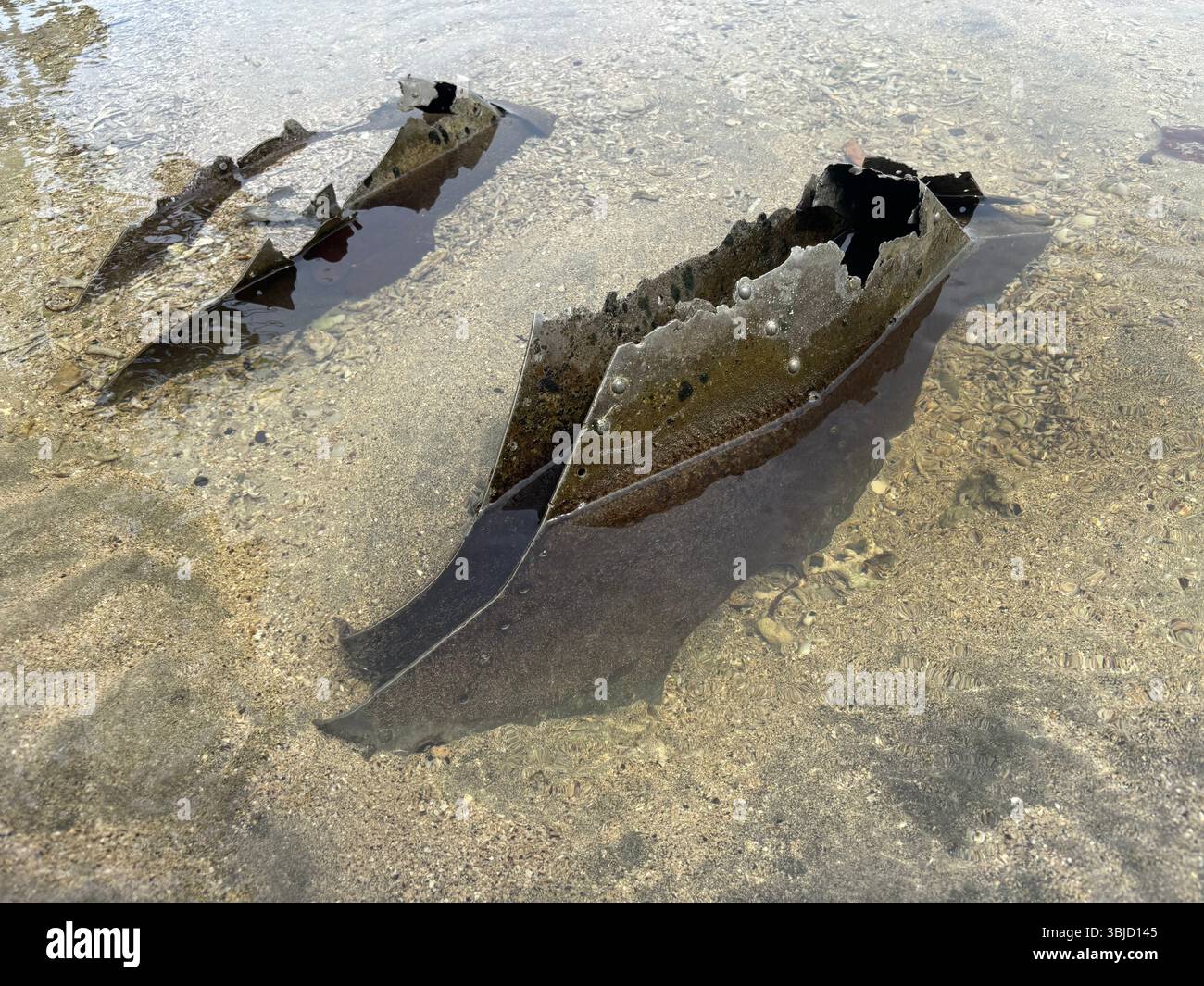 Metal riveted parts of a wrecked Japanese warplane that crashed on the beach in WWII, southwestern Tetepare Island, Western Province, Solomon Islands - Smartphone Captured Stock Image Metal riveted parts of a wrecked Japanese warplane that crashed on the beach in WWII, southwestern Tetepare Island, Western Province, Solomon Islands - Smartphone Captured Stock Image