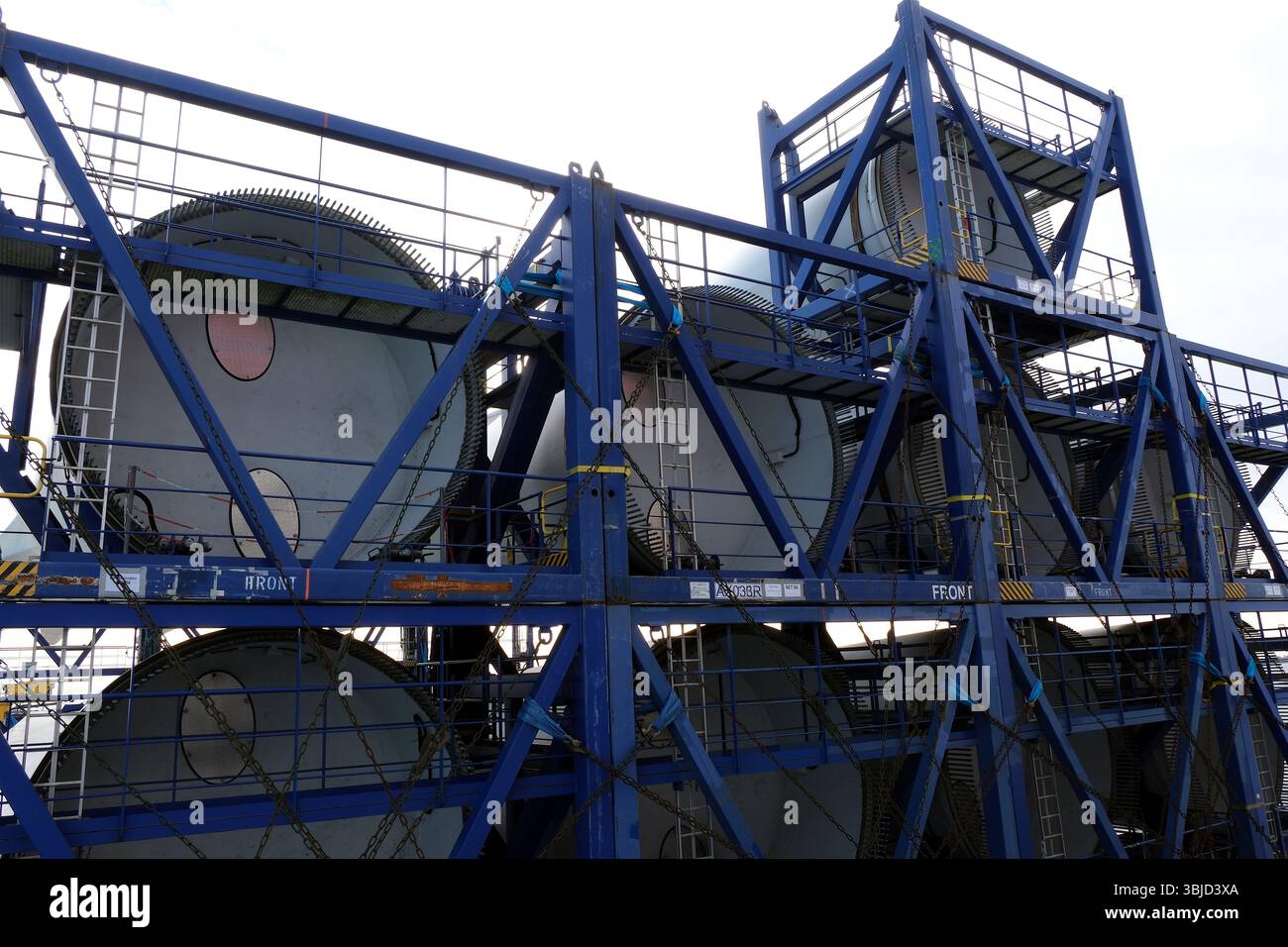 Root ends of long blades of wind turbine loaded and lashed on the heavy ...