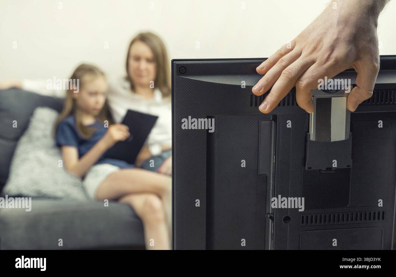 Man installing conditional access module card to TV Stock Photo - Alamy