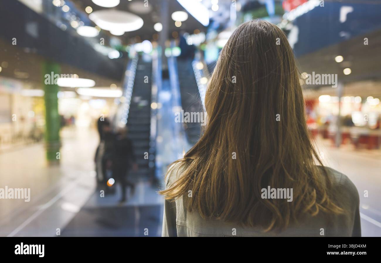 Girl in lift in a large shopping center Stock Photo
