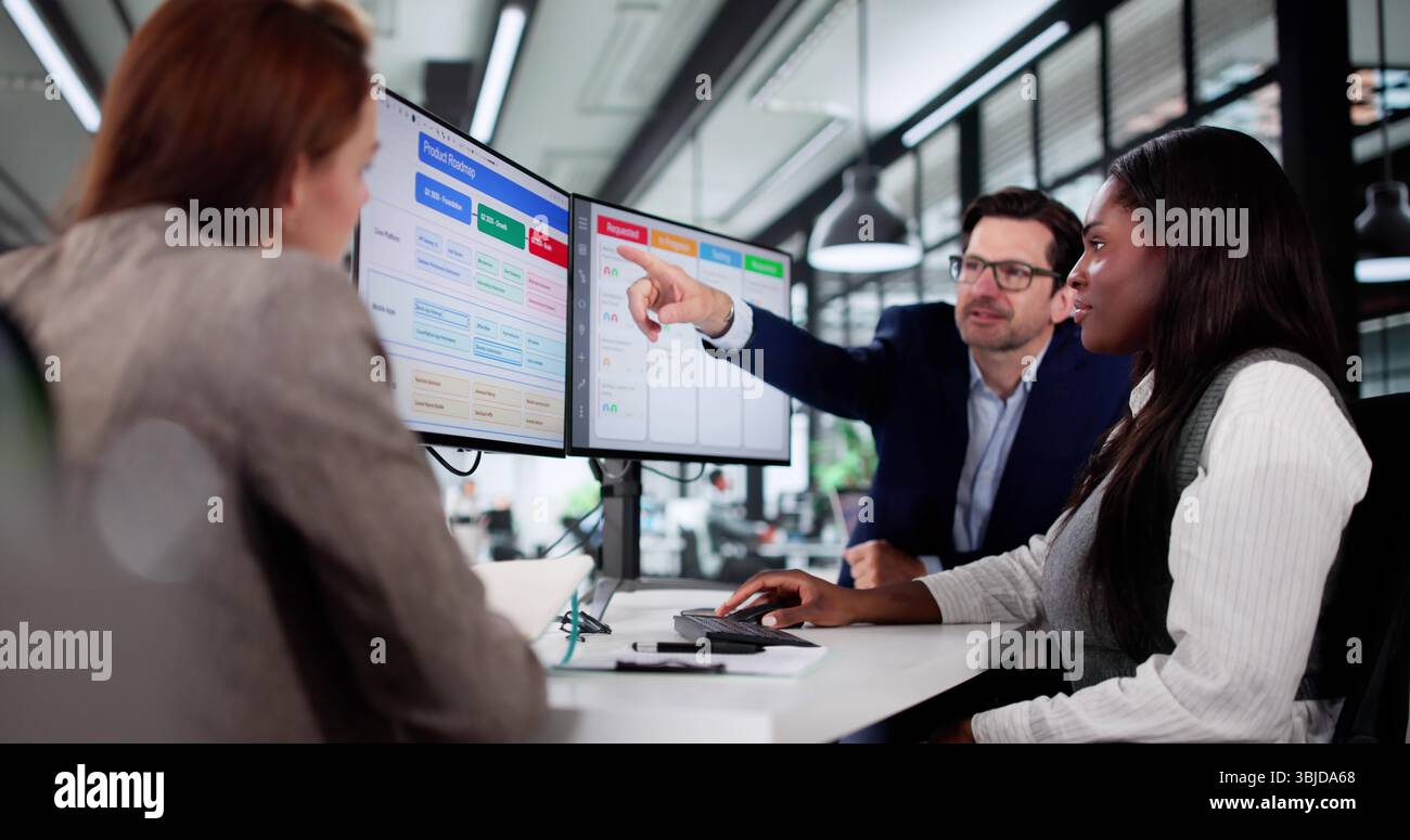 Multiracial Manager Uses Kanban Software On Laptop To Schedule Project. Stock Photo