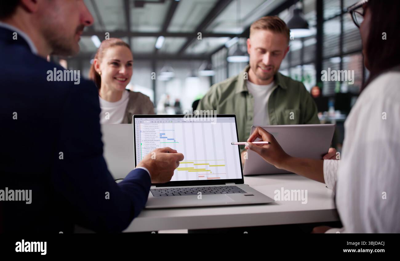 Multiracial Team Using Calendar Software To Meet Project Deadline Stock Photo