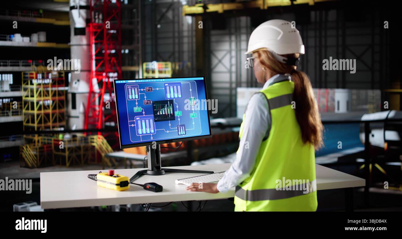 African American Woman Operating Scada System At Industrial Factory. Stock Photo