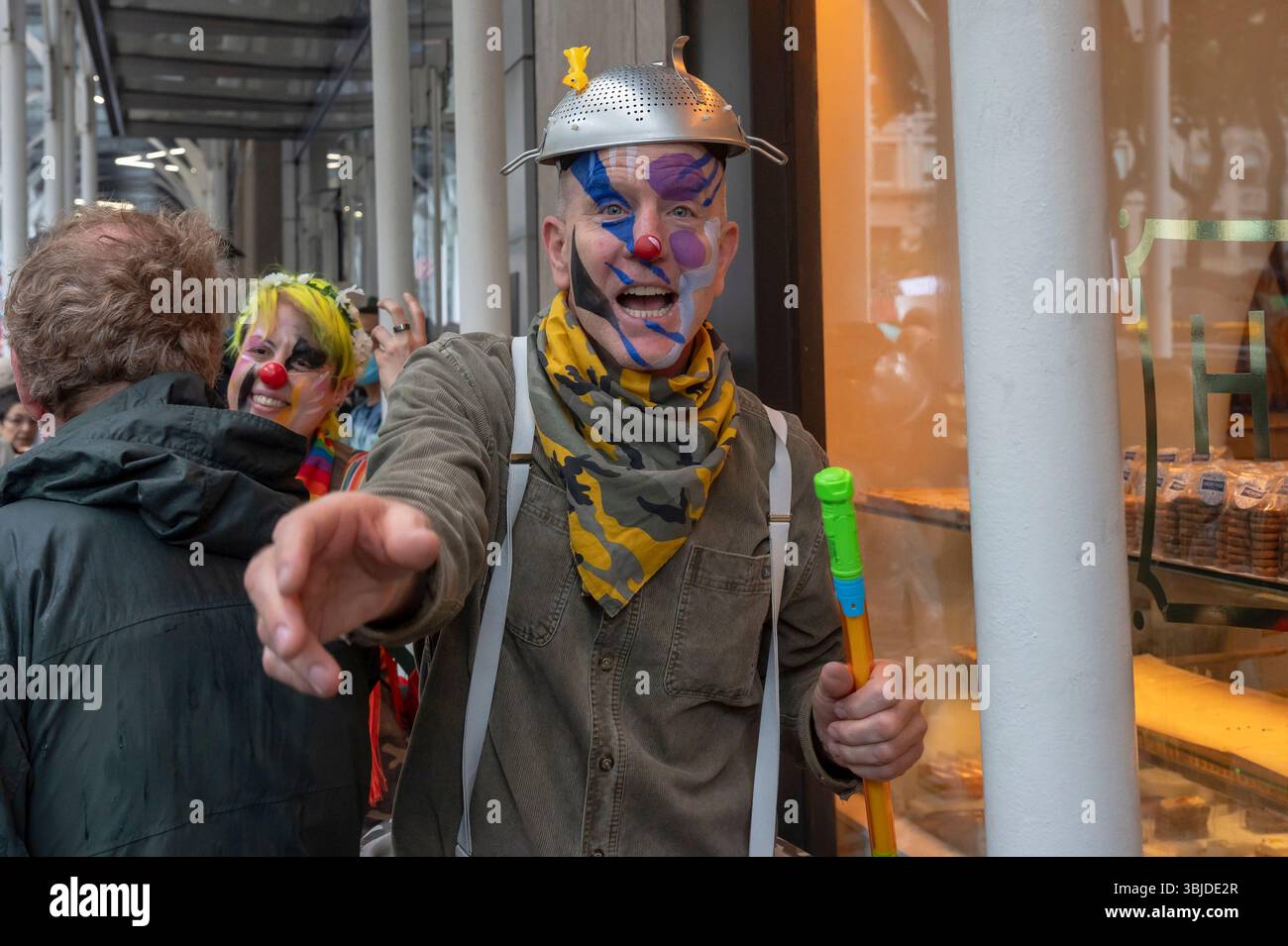 a-man-with-painted-face-as-clown-seen-as-thousands-of-people-march-in