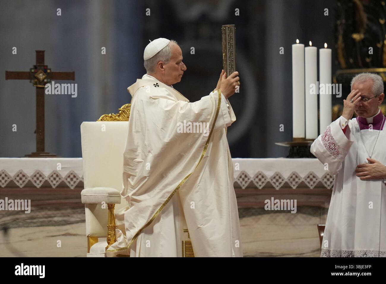 Pope Leo XIV hoists the Gospel book, as Vatican Master of Liturgical ...