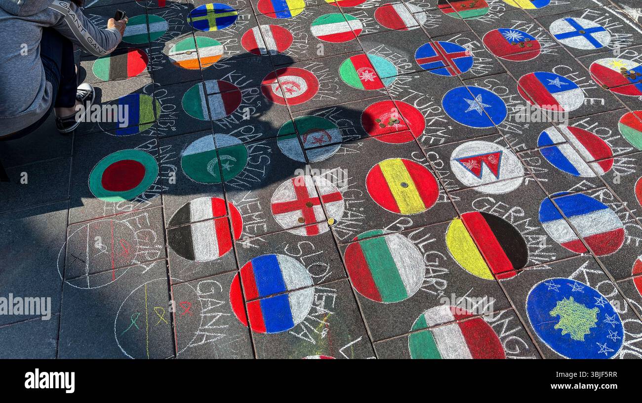 Chalk-drawn national flags on the pavement at Narinkka on a June afternoon. - Smartphone Captured Stock Image