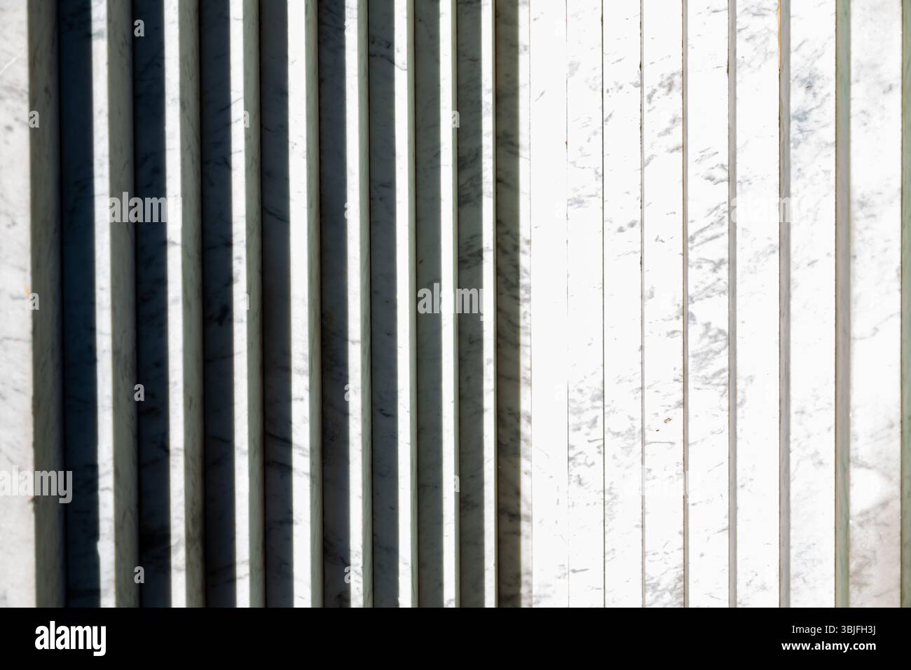 Abstract white marble background with vertical stripes and shadows. Stock Photo