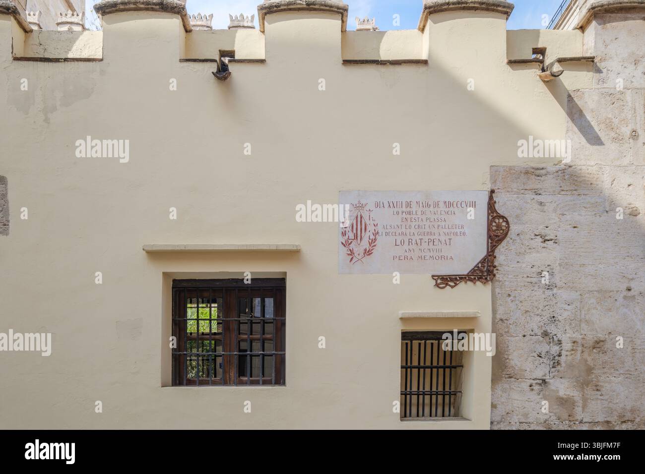 Historic Wall with Battlements and Ornate Plaque in Sunny Valencia. Ancient Fortification, Medieval Architecture, Stone Texture, The ancient stone sho Stock Photo