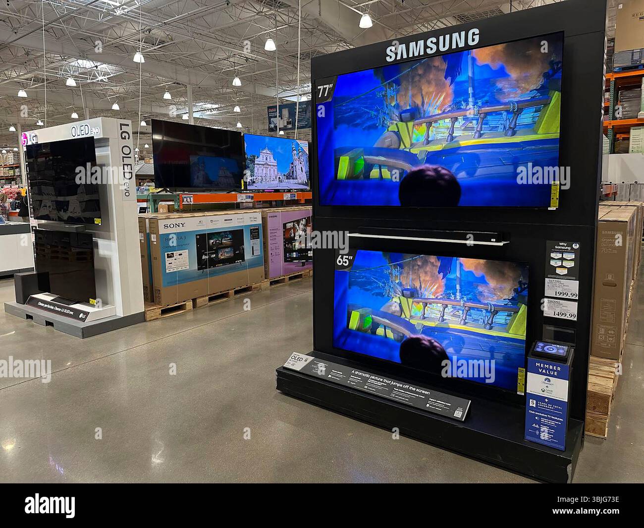 Big-screen televions stand on display in a Costco warehouse Wednesday ...