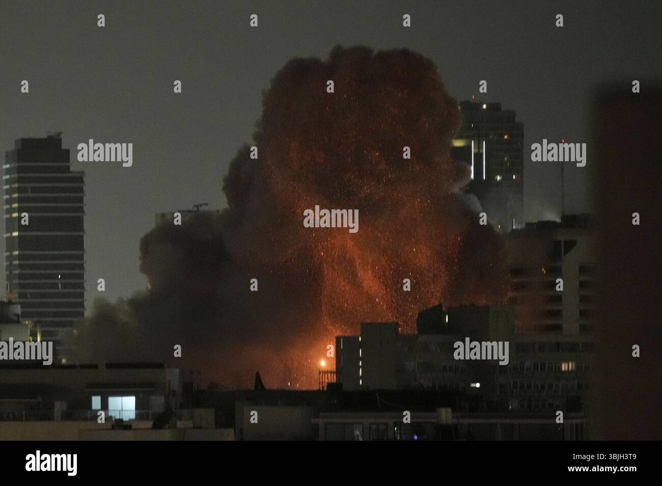 An explosion is seen during a missile attack in Tel Aviv, Israel ...