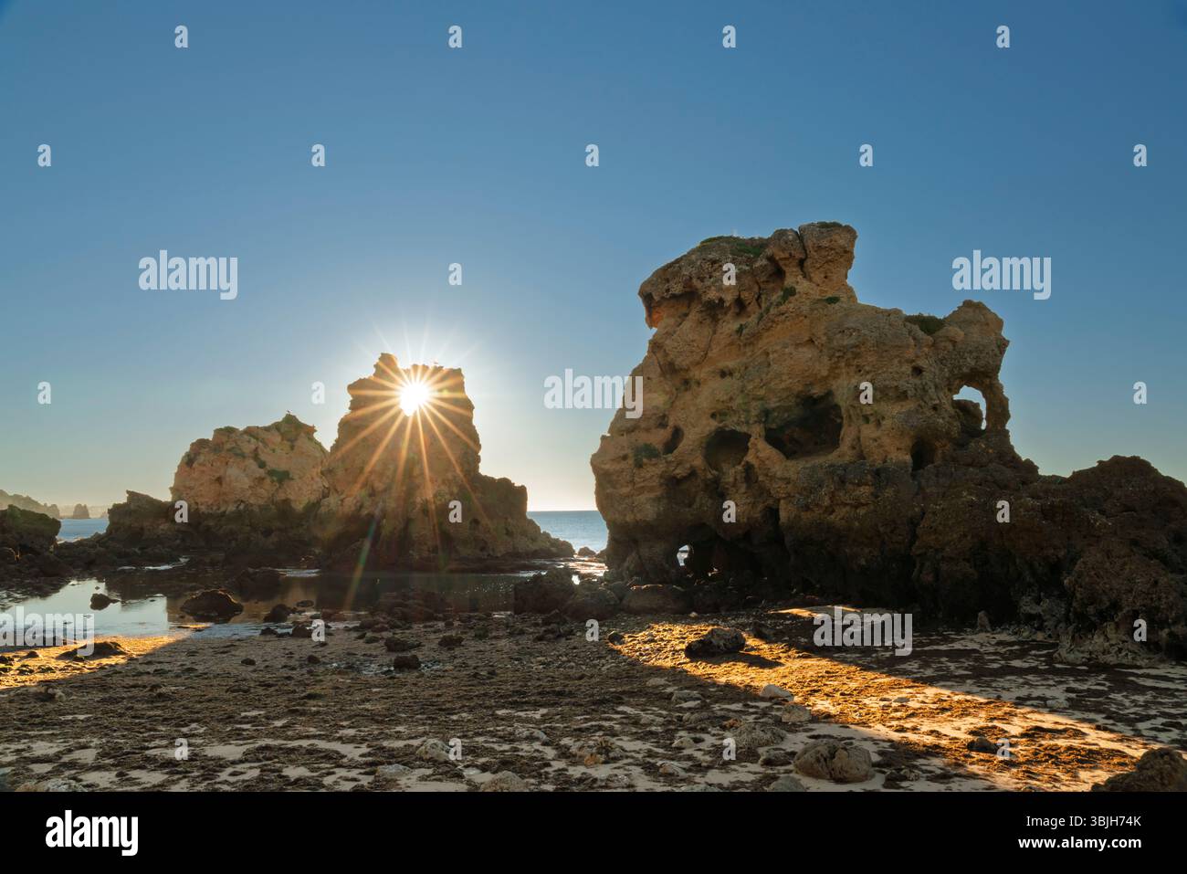 Coastal rock formations and sea stacks on Arrifes Beach at sunrise,, Algarve, Portugal, Europe. Stock Photo