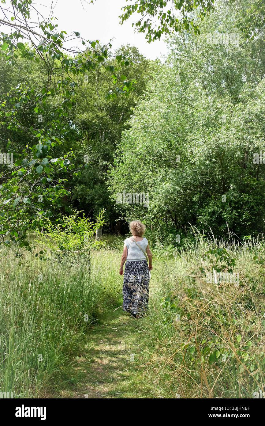 Cambridge UK June 2025 - Female visitor enjoying The Cambridge University Botanic Garden Stock Photo