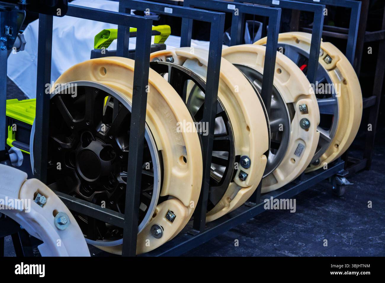 Rack of multiple run-flat tire inserts and rims, highlighting advanced ...