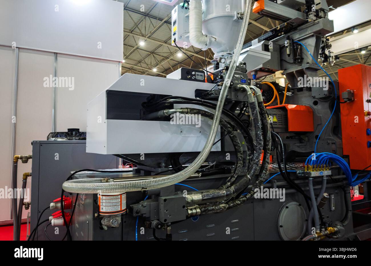 Close-up detail of complex industrial plastic injection molding machine ...