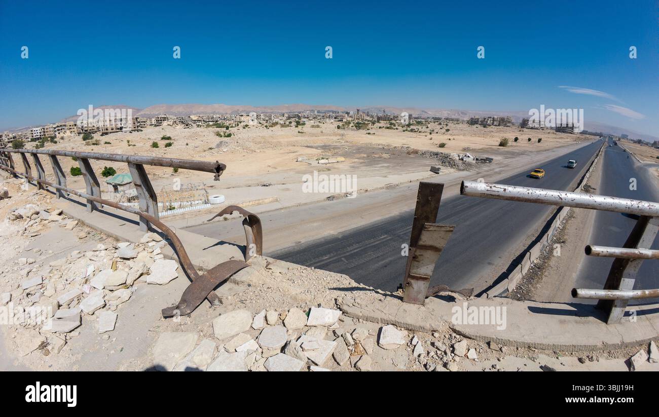 Damege Railing A panoramic view of a deserted landscape with a highway and abandoned ...