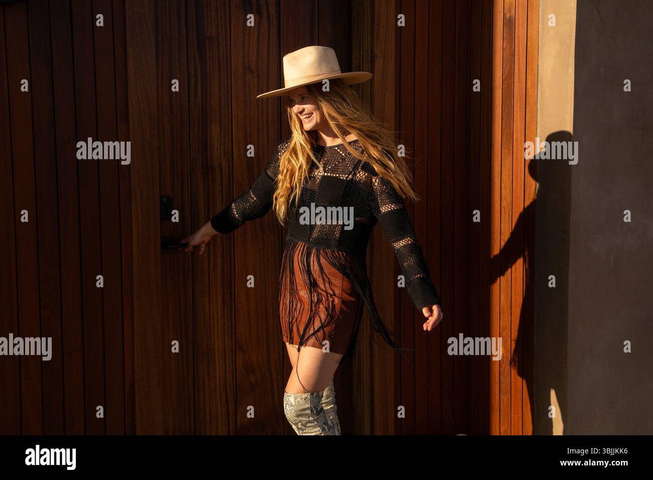 Bohemian dressed women with hat in desert Stock Photo