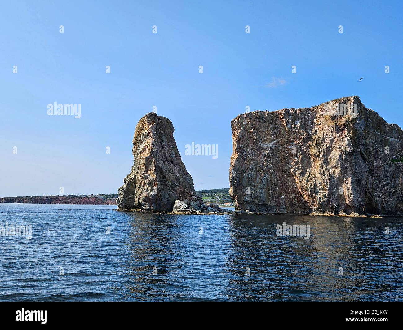 Dramatic limestone sea stacks and cliffs rising from blue ocean waters creating spectacular coastal geological formations - Smartphone Captured Stock Image