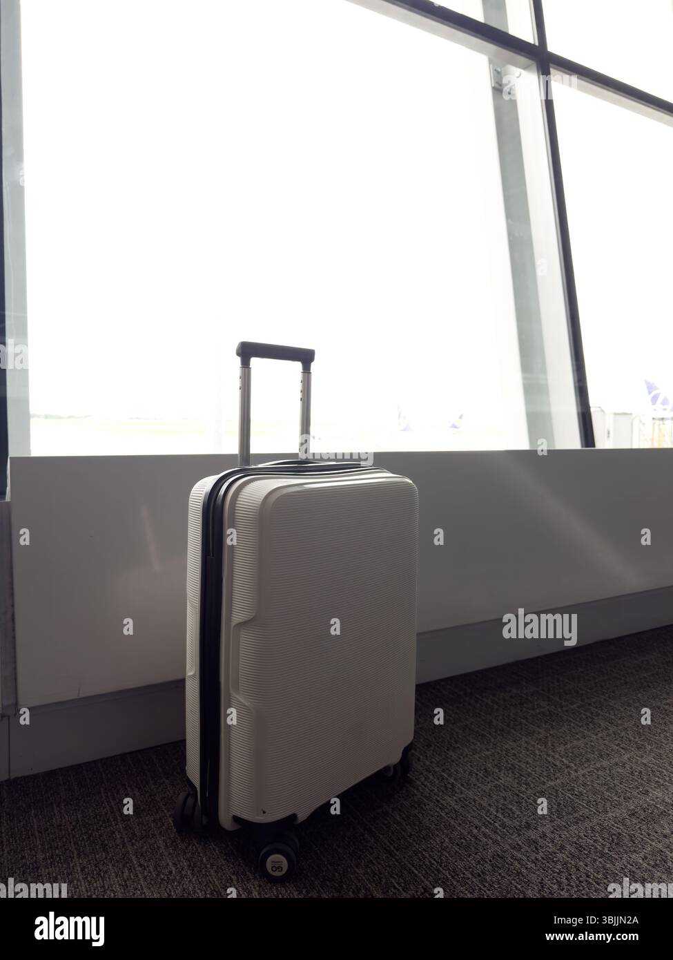 Lonely suitcase in the airport waiting area - Smartphone Captured Stock Image
