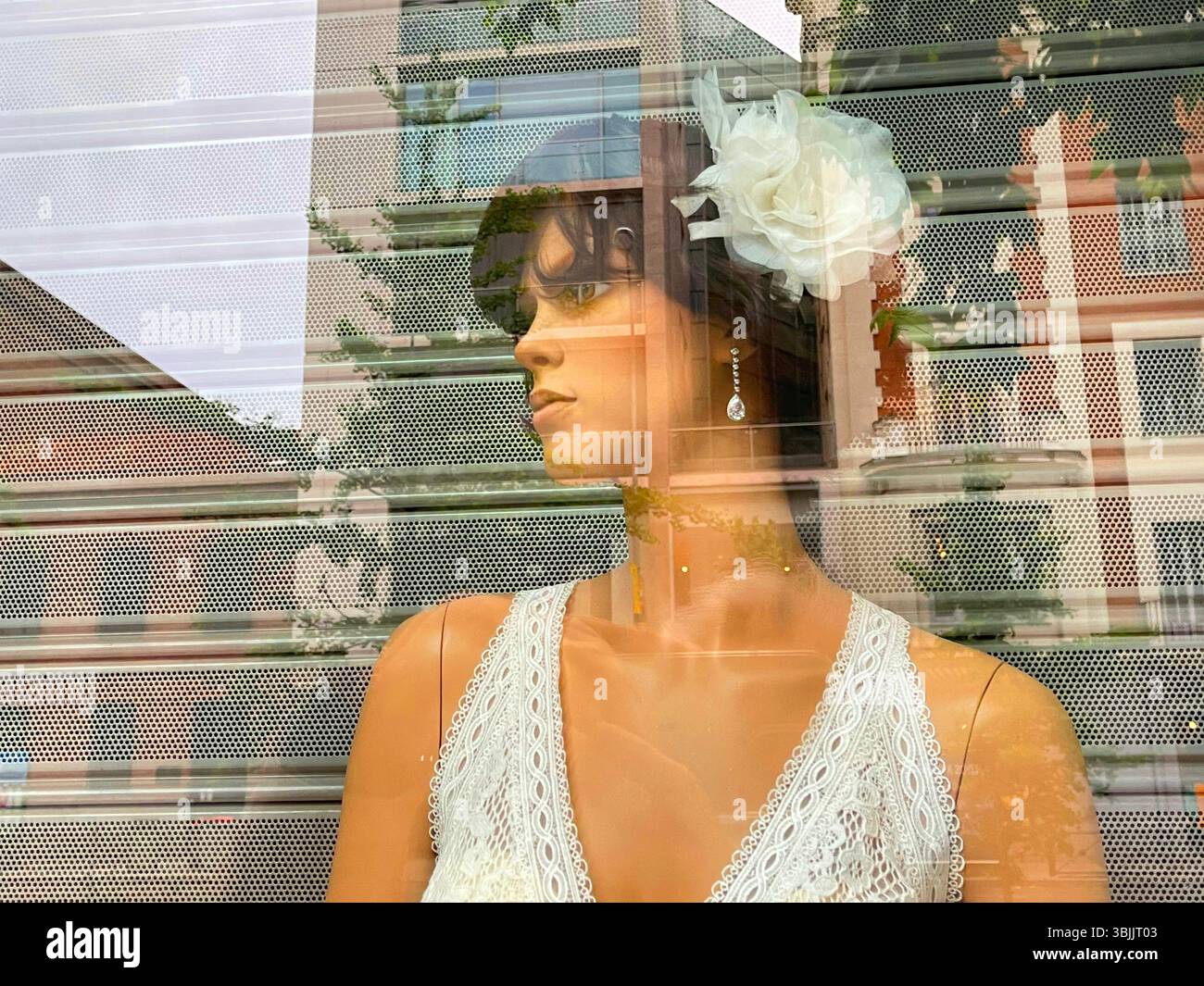 Mannequin wearing wedding dress in a shop window. Madrid, Spain. - Smartphone Captured Stock Image