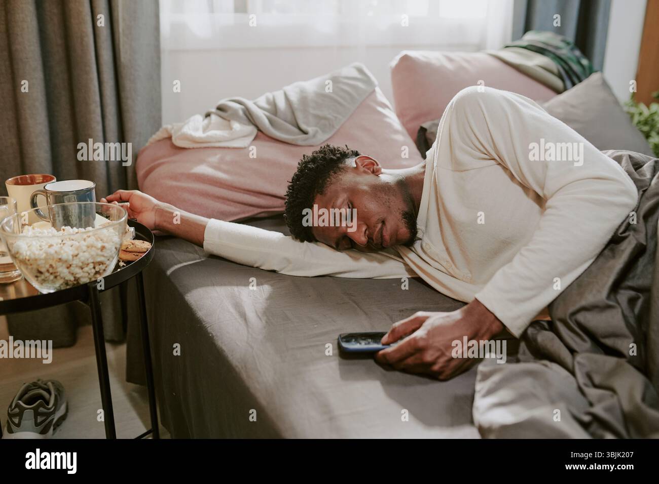 African American Man Sleeping Peacefully on Couch Stock Photo