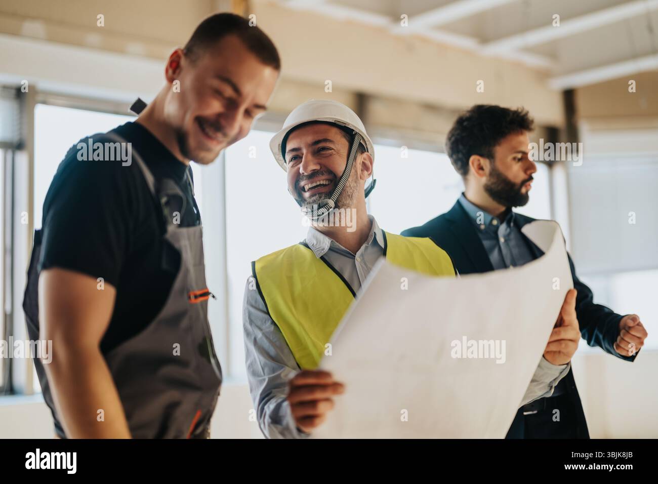 Engineers and architects collaborating on a construction site project Stock Photo