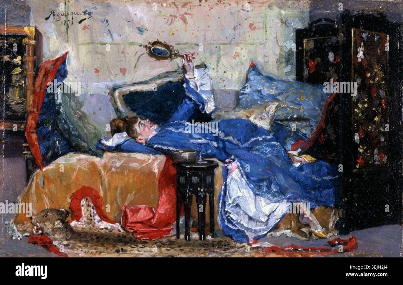 Rogelio de Egusquiza (1845–1915) painted 'Reclining Woman with Mirror' in 1873. This oil on panel painting portrays a woman lying on a chaise, gazing into a mirror. The subject captures a moment of reflection and introspection, displaying the artist's skill in capturing human form and light. Stock Photo