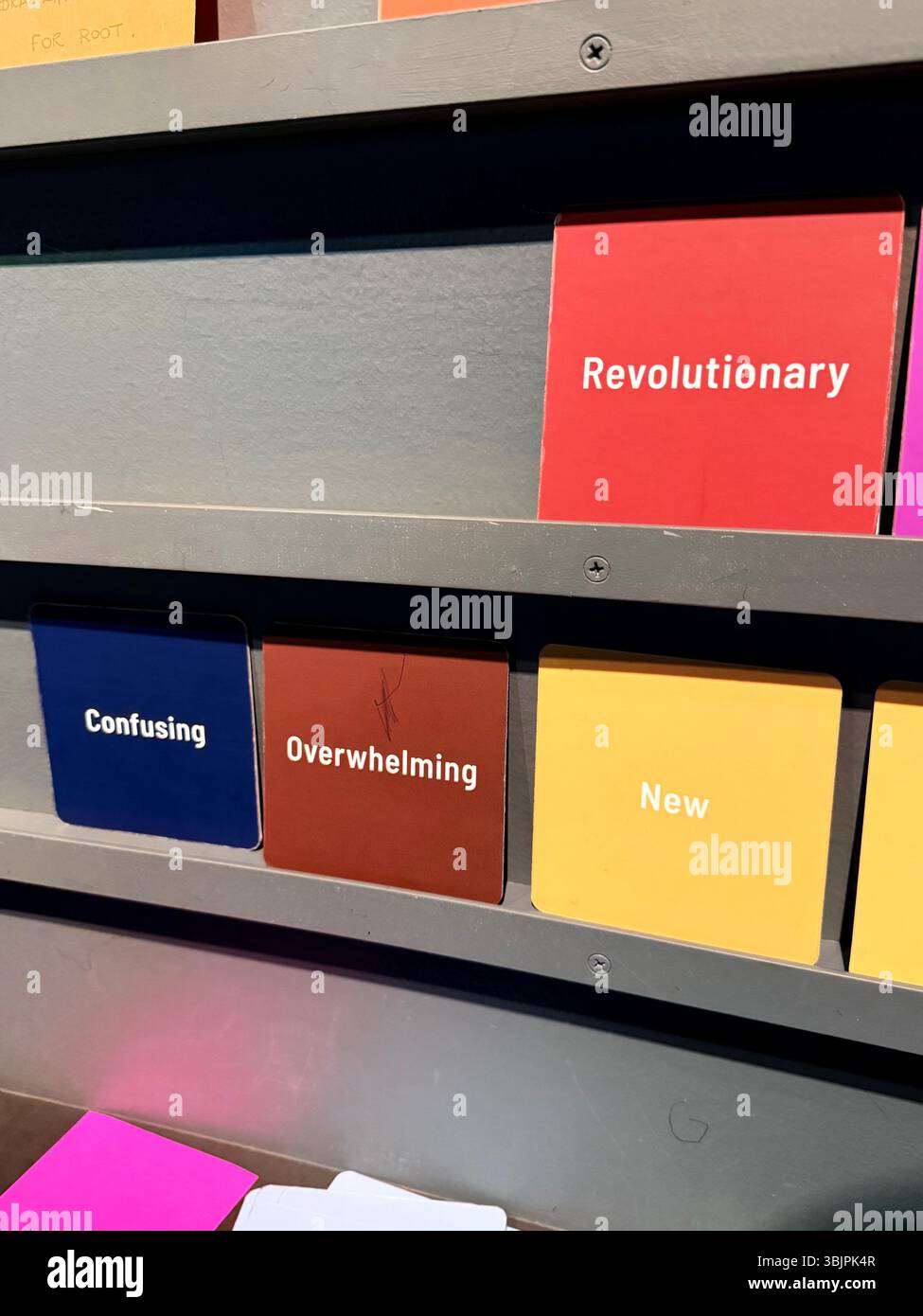 Small cards reading 'confusing,' 'revolutionary,' 'overwhelming,' 'new.' - Smartphone Captured Stock Image