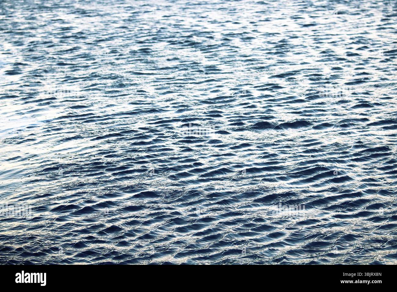 Small beautiful ripples on sea surface . Light day cool breeze Stock Photo