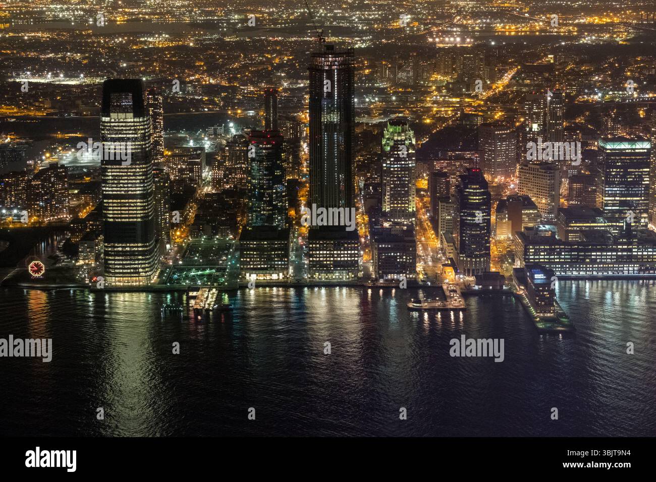 Aerial view of bustling city skyline at night with vibrant water ...