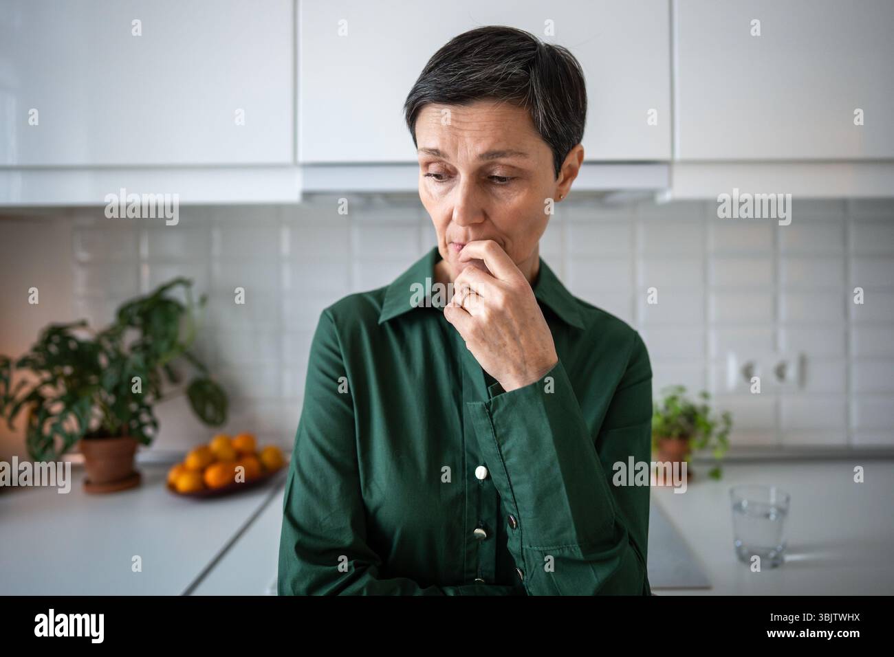 Sad pensive mature woman standing lost in sorrowful thoughts waiting ...
