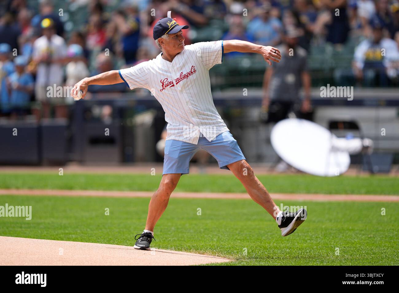 Leinenkugel throws out a ceremonial first pitch before a baseball Leinenkugel throws out a ceremonial first pitch before a baseball