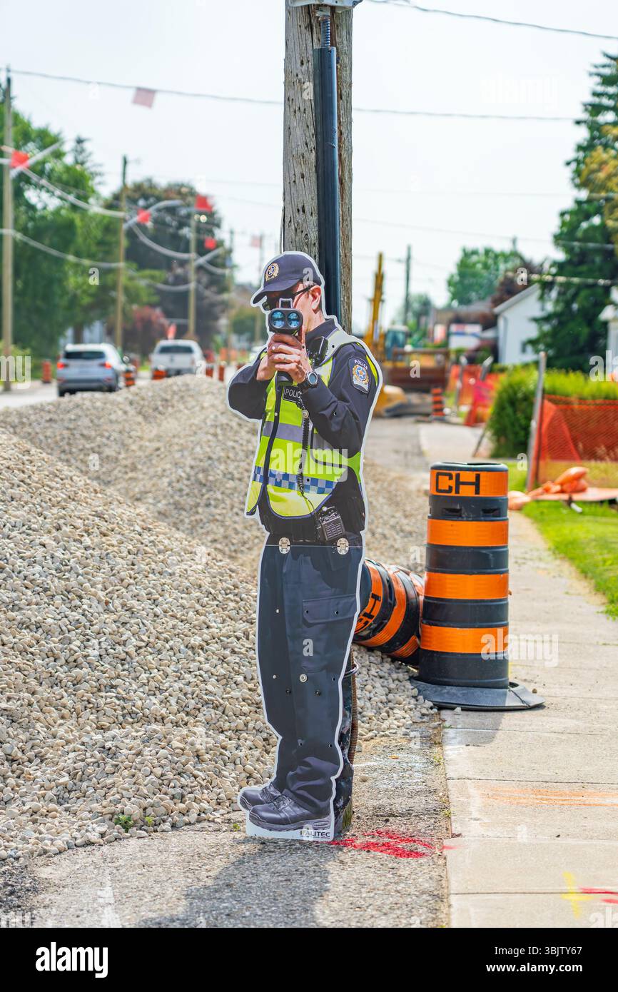 Cutout of a police officer holding a radar gun deployed in an attempt ...