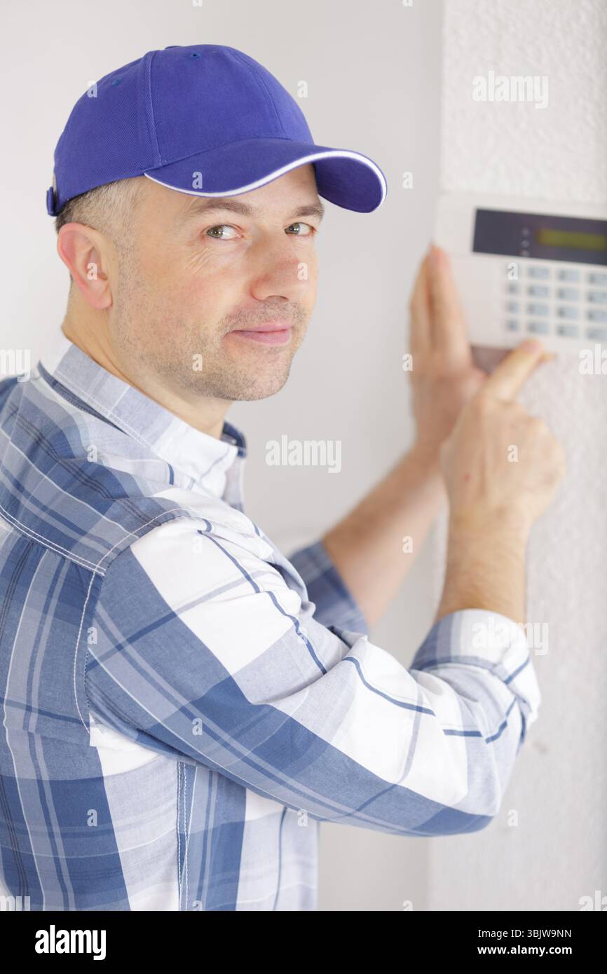 young male technician installing security system Stock Photo