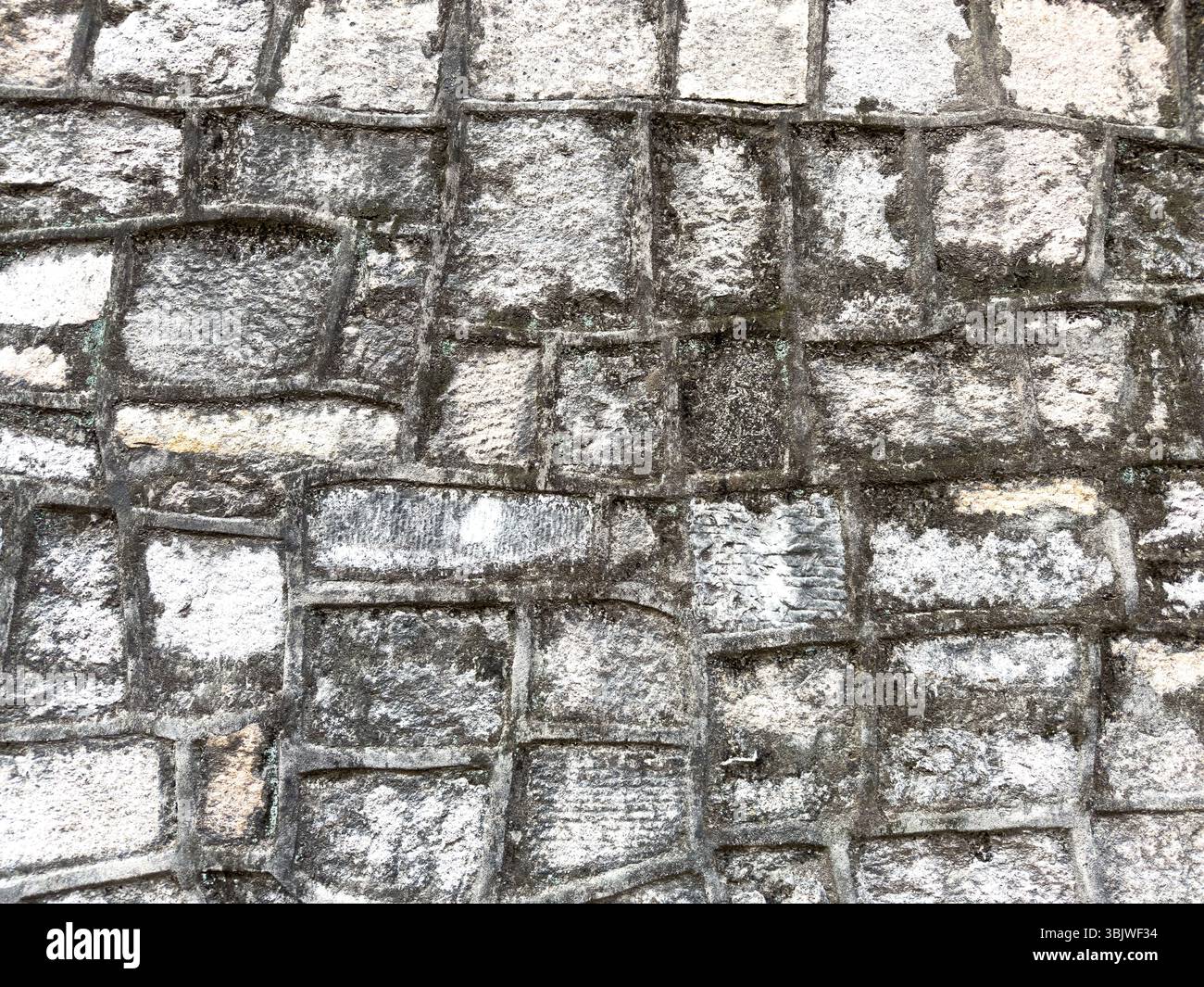 Old stone wall with rectangular granite blocks background, closeup view Stock Photo