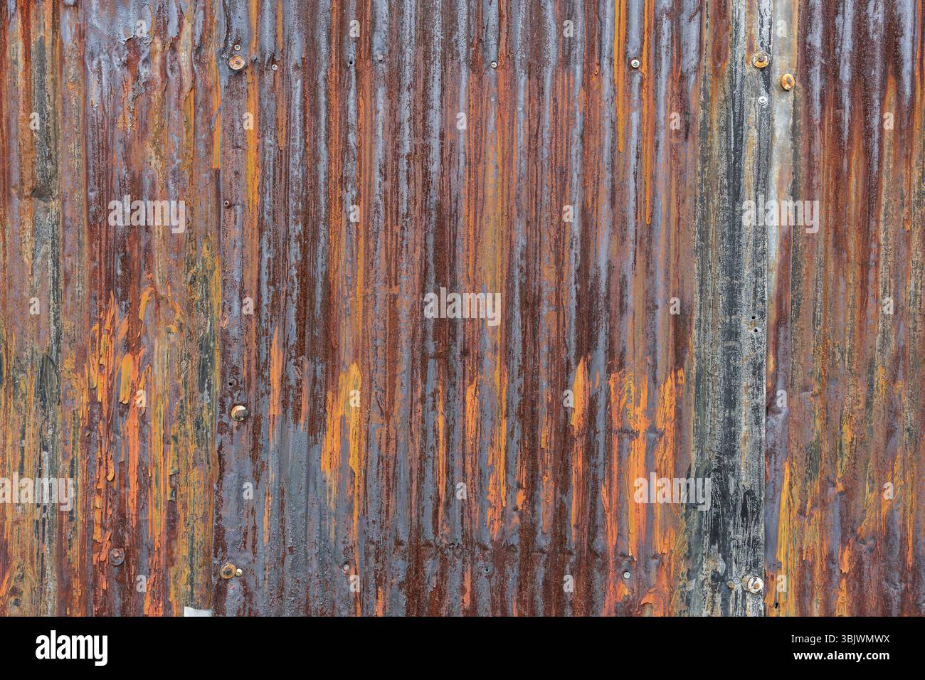 Rusted corrugated metal siding with an array of earthy tones resembling ...