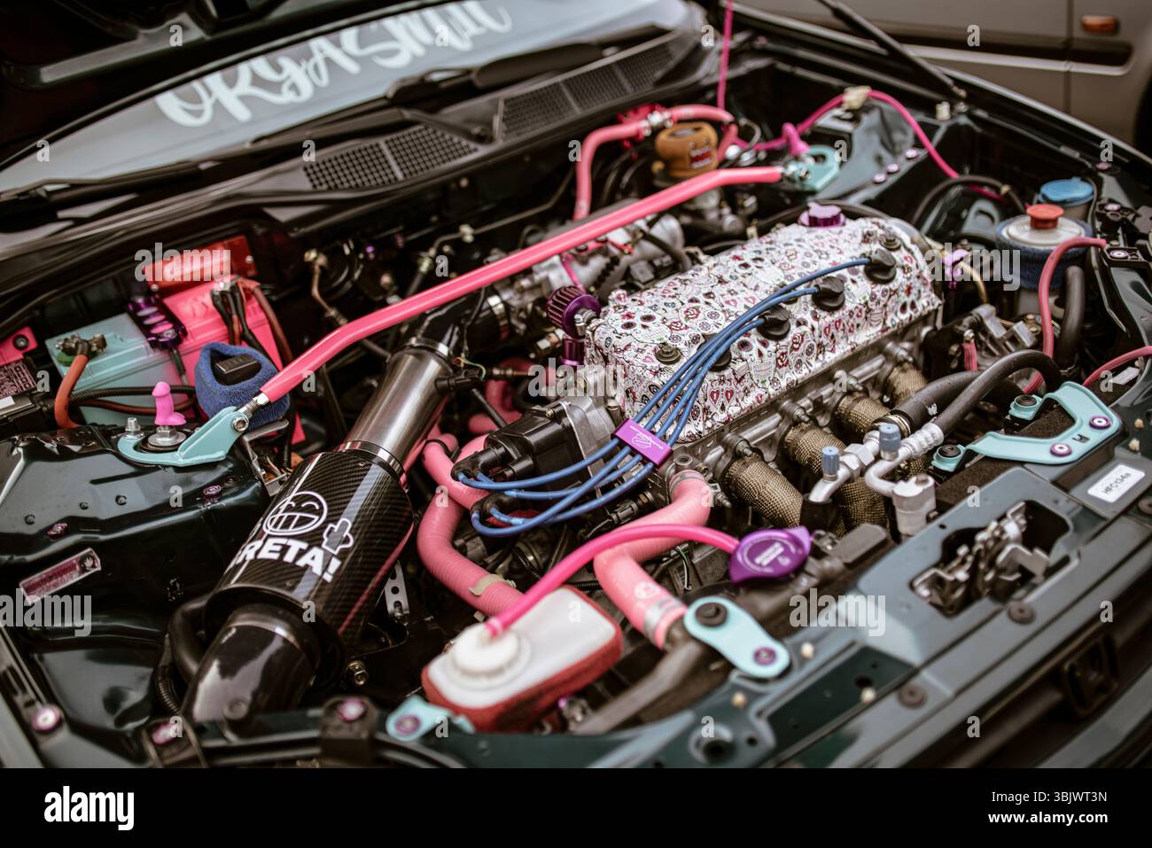 Rome, italy 17 june 2025, pink and teal car engine featuring tuning and ...