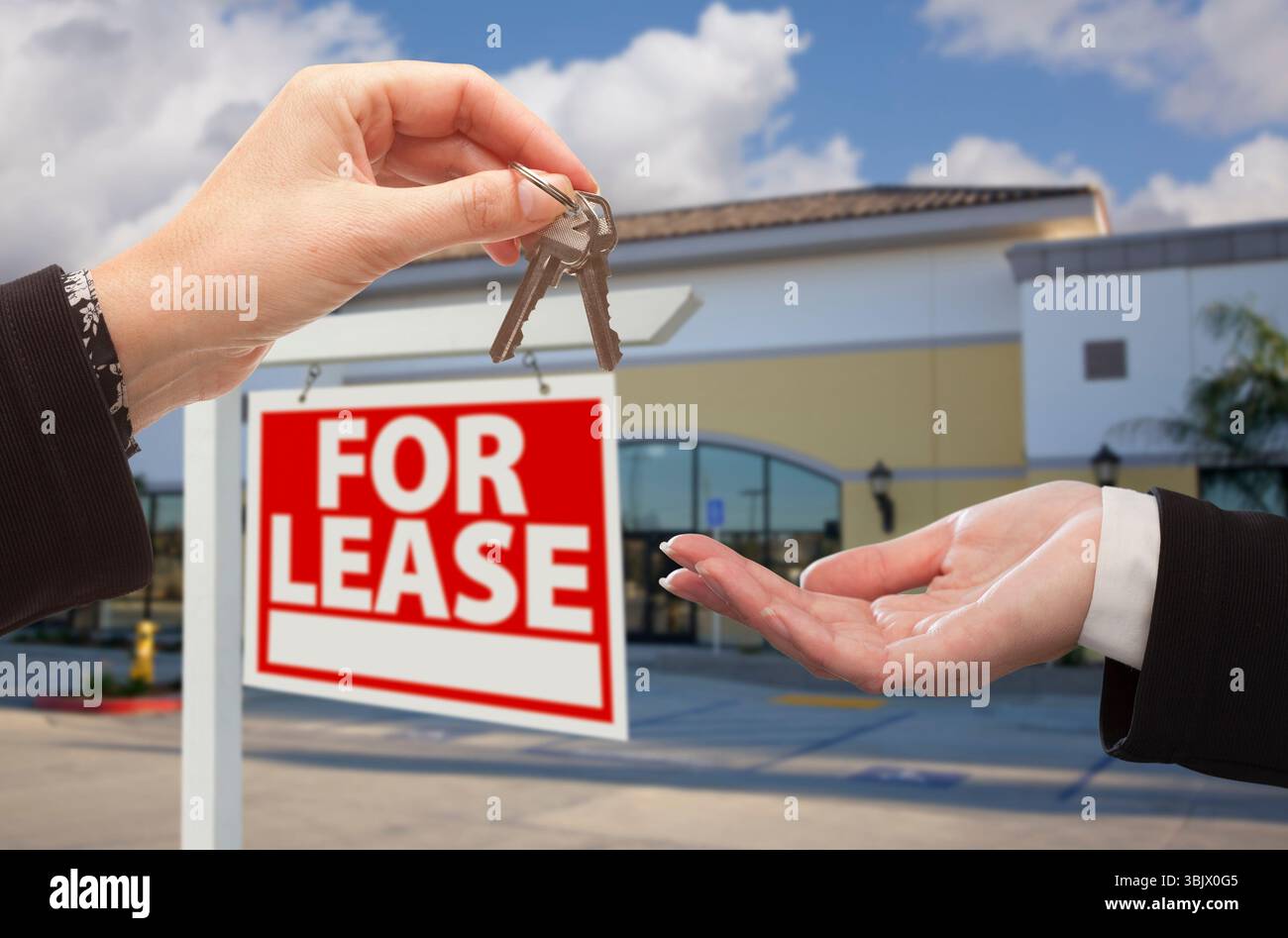 Front Desk Key Sign Handing Keys in Front of Office and For Lease Sign Stock Photo - Alamy