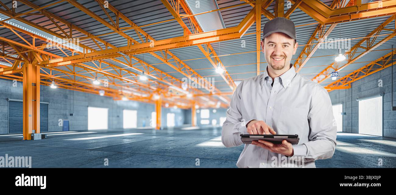 man using digital tablet large empty warehouse Stock Photo
