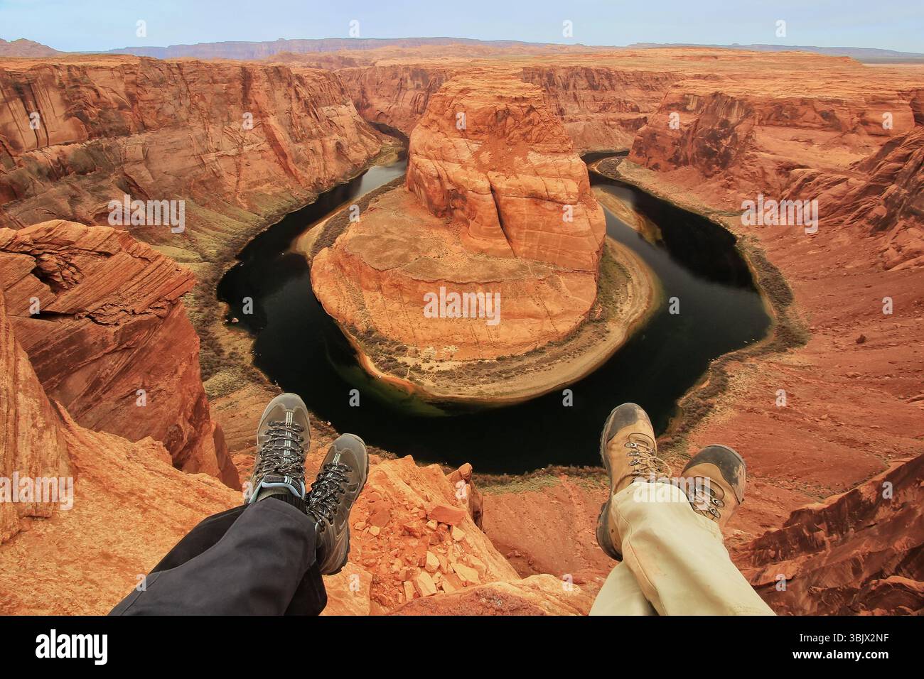 Two pairs of legs at Horseshoe bend overlook, adve Stock Photo - Alamy