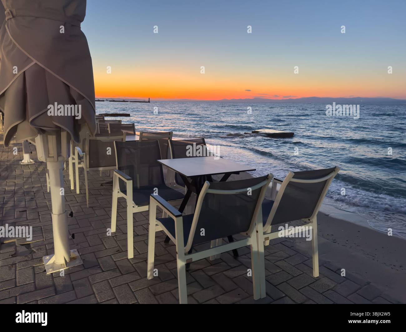 Restaurant on the beach on Chalkidiki island at sunset in Greece Stock Photo
