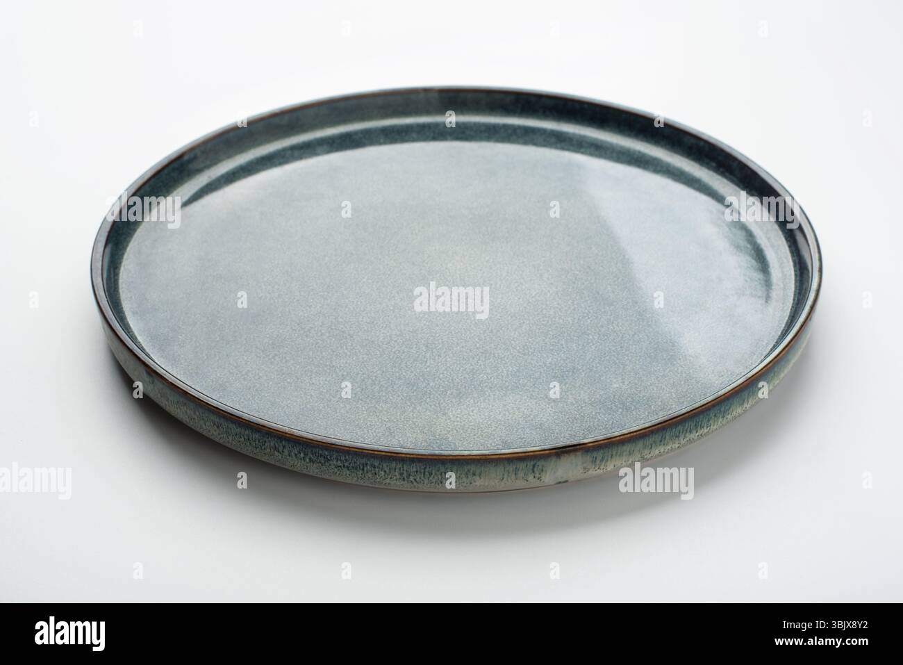 Empty textured plate on white background Stock Photo
