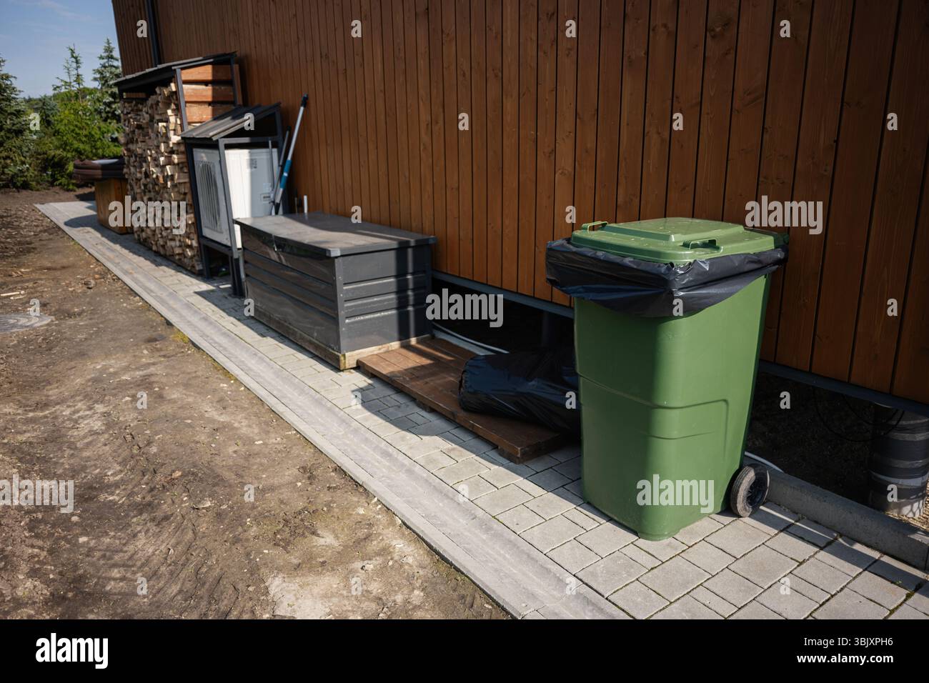 Outdoor waste disposal area with bins, containers, and neat ...