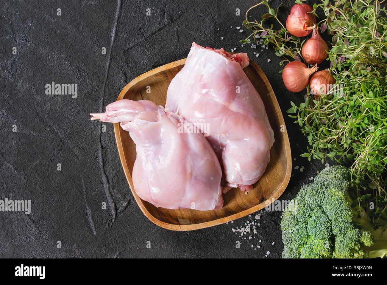 Raw rabbit legs with vegetables Stock Photo
