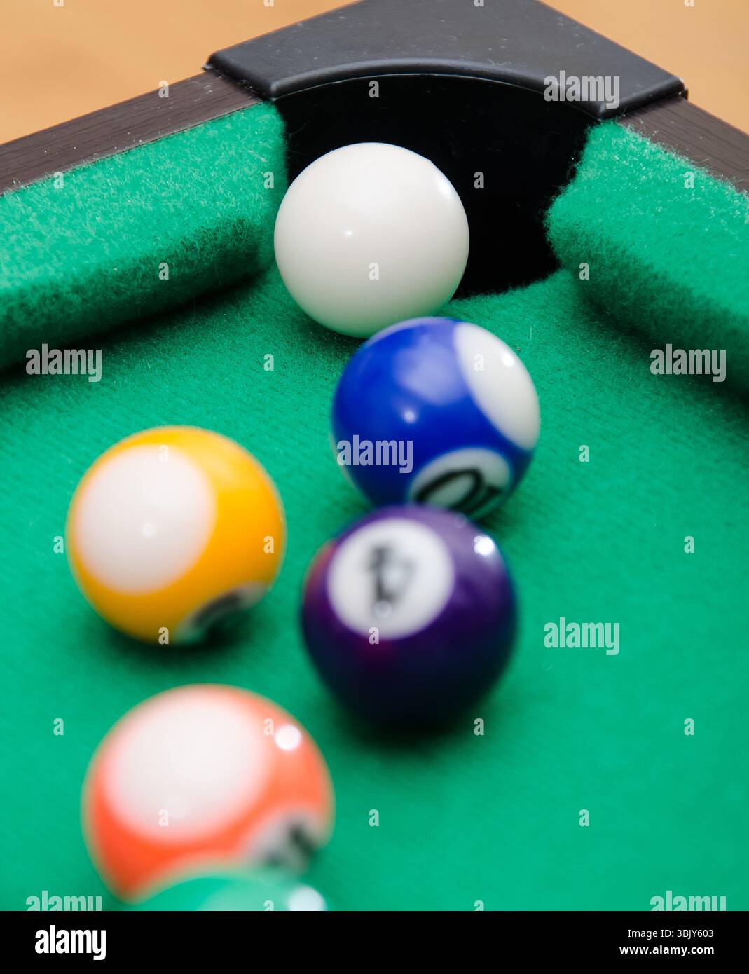 Pool game balls on green felt table Stock Photo