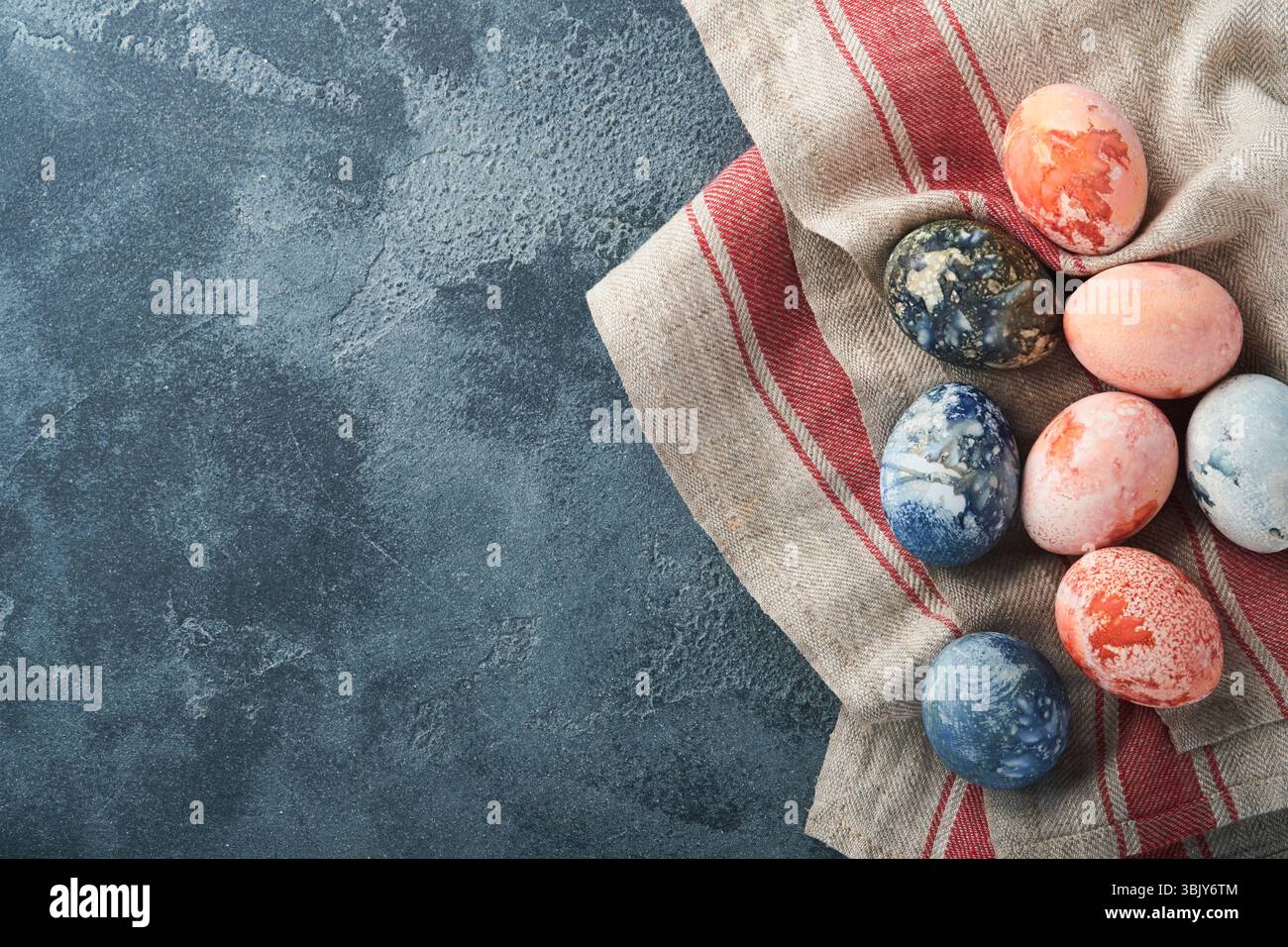 Easter eggs. Dyed Easter eggs with marble stone effect ref and blue color in rustic style on dark stone background. Easter back Stock Photo